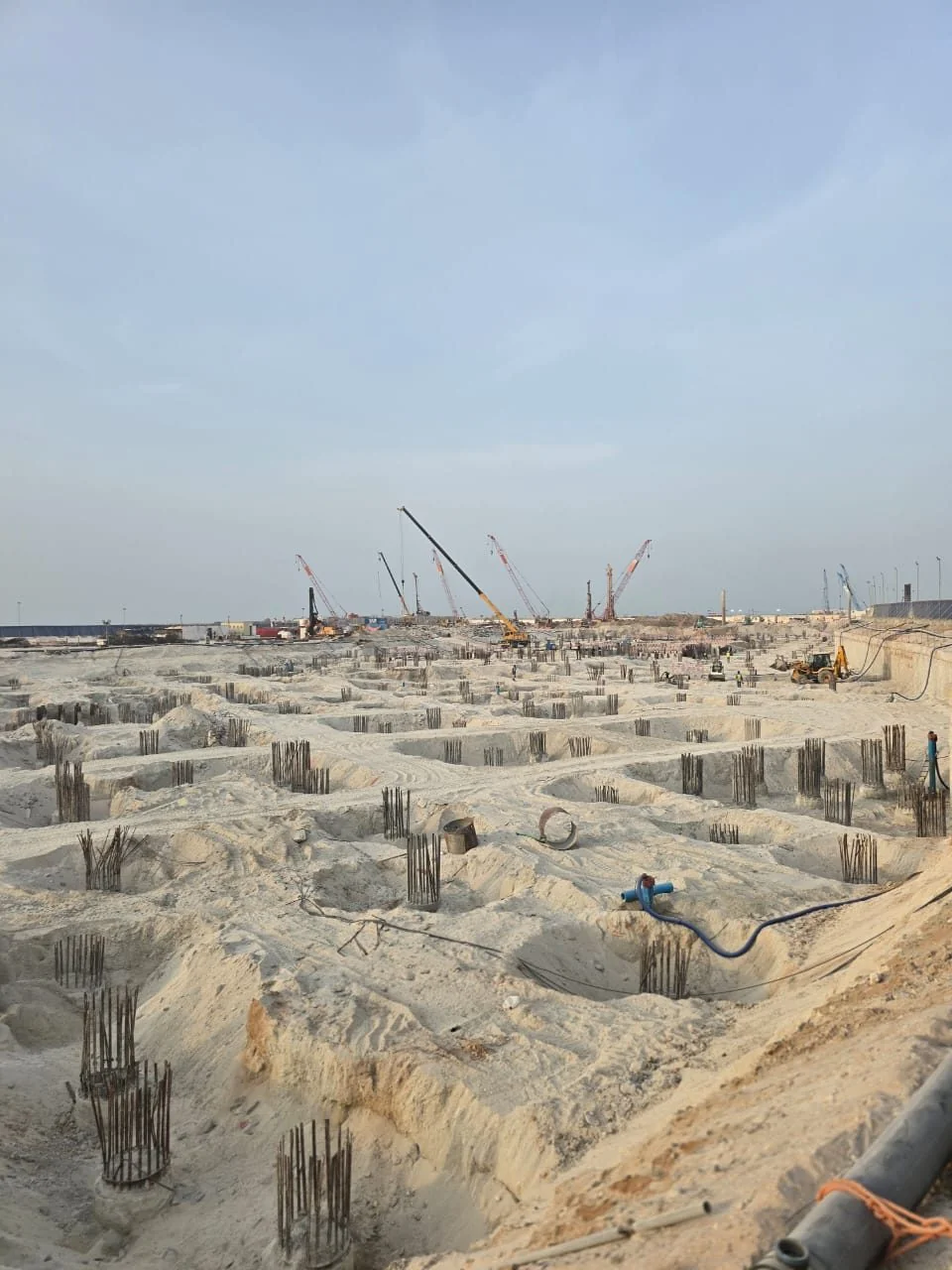 Dry pile caps across a dewatered excavation